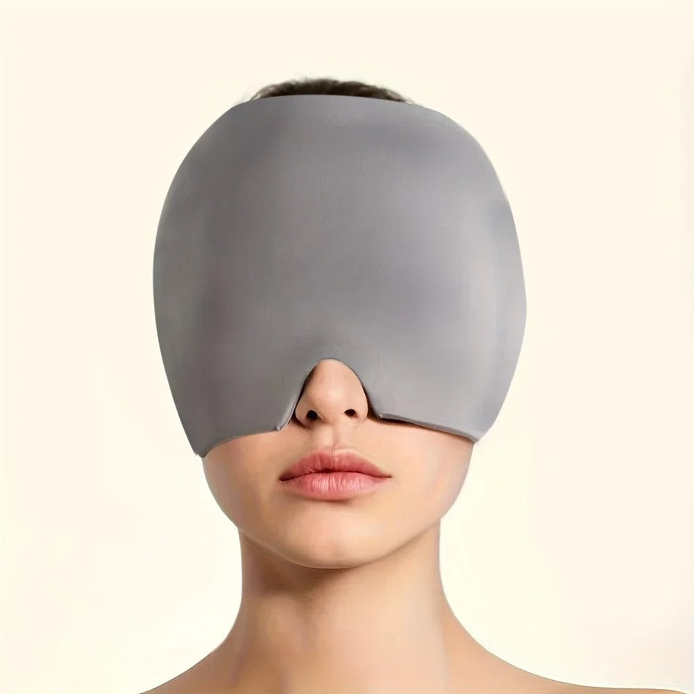 Grey headache, stress, pain relief mask covering eyes on a plain background
