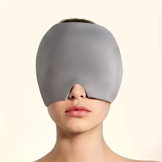 Grey headache, stress, pain relief mask covering eyes on a plain background